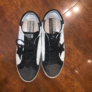Golden Goose Superstar shoes. Black and white